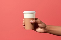 Coffee cup on hand holding latte drink.