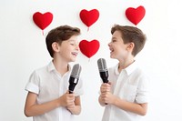 Two boys singing their hearts out microphone karaoke white background.