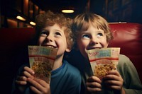 Children holding movie tickets portrait popcorn snack.
