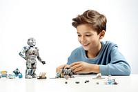 Young boy playing with robot toys child white background technology.