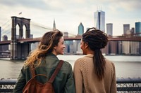 Mixed race friends travel new york bridge adult togetherness.