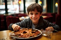 Spanish boy eating paella restaurant portrait pizza.