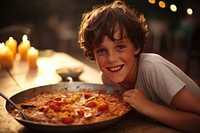 Spanish boy eating paella pizza child food.