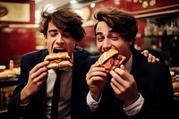 Spanish boys eating a jamon sandwich inside a sandwich shop adult food togetherness.