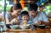 Thai family eat noodle restaurant father eating.