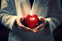 Doctor holding a heart adult expertise standing. AI generated Image by rawpixel.
