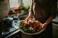 Women holding a Platter With Roast Turkey kitchen thanksgiving dinner.