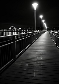 Photography of riverside boardwalk lighting railing.