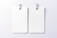 A couple of keychains with white label plastic tag white background accessories electronics.