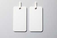 A couple of keychains with white label plastic tag white background electronics hardware.