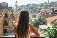 Lebanese female tourist looking at old town architecture cityscape building.