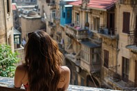 Lebanese female tourist looking at old town architecture cityscape building.