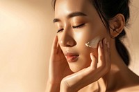 Vietnamese woman with a healthy glowing skin cosmetics portrait applying.