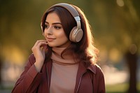Qatari woman headphones listening portrait.