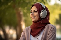 Qatari woman headphones listening smile.