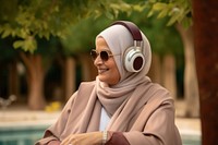 Qatari senior woman headphones listening headset.
