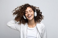 Brunette young woman dancing happy and cheerful headphones listening laughing.