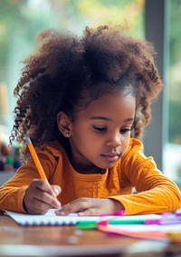 Cute little african american girl homework writing child.