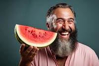 Middle eastern man eating watermelon laughing smiling summer.