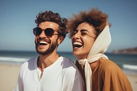 Middle eastern woman boy and girl enjoying summer at the beach laughing portrait smiling.