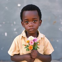 A little boy holding flowers portrait plant photo.