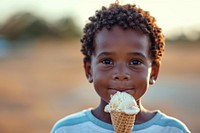 A little boy holding an ice cream cone dessert child food.