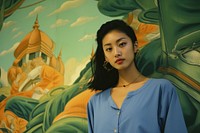 Thai girl painting portrait contemplation.