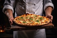 The chef holds a pizza in his hands food adult mozzarella.