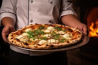 The chef holds a pizza in his hands food oven mozzarella.