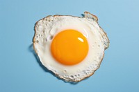 Top view of fried egg on blue frying pan food freshness jewelry.