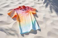  Tie dye shirt t-shirt sleeve sand. AI generated Image by rawpixel.