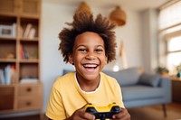 A american african boy in yellow sweater holding a Controller smile child photo. AI generated Image by rawpixel.