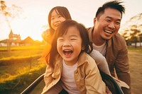 Asian family cheerful laughing sunset.