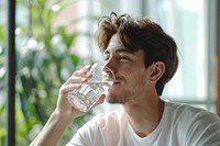 A man drinking a glass of water person adult day. AI generated Image by rawpixel.