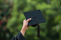Graduation cap student holding hand.