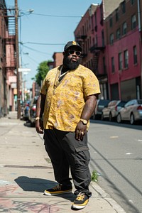 Fat black rapper street footwear standing.