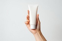 Hand holding sunscreen cosmetics white background beverage.