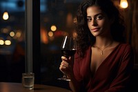 Lebanese woman drinking red wine at a restaurant glass table adult.