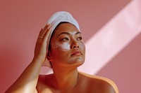 Chubby Pacific Islander woman doing skincare routine adult relaxation headshot.