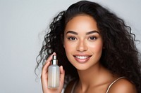 A Pacific Islander womans with skincare product cosmetics portrait perfume.