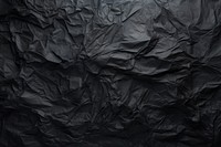 Dark Crumpled Paper Texture backgrounds crumpled black. AI generated Image by rawpixel.