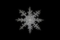 Frosted ice star frame snowflake winter black background.