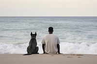 Man and white dog sitting at beach outdoors horizon nature.