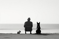 Man and white dog sitting at beach silhouette outdoors nature.