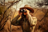 Woman using Binoculars binoculars adult photo. 