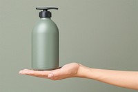 Hand holding color bottle hand container beverage.