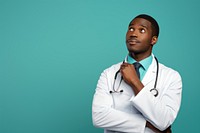 African Male doctor looking up with arms crossed adult male stethoscope.