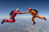 Skydiving friends holding hands skydiving recreation adventure.