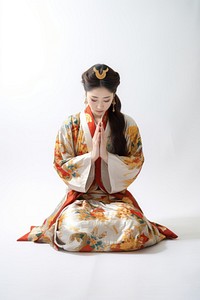 A Chinese woman wearing traditional attire is praying kimono adult robe. AI generated Image by rawpixel.