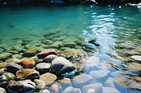 Pebbles and stones arranged in the water of a river pebble outdoors nature. AI generated Image by rawpixel.